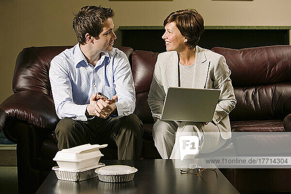 Businesswoman Using A Laptop In Casual Lunch Meeting With A Colleague  Toronto  Ontario