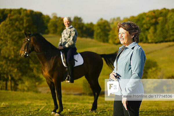 Couple On Farm  Man On Horseback