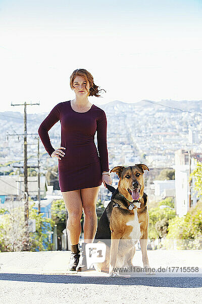 A Redheaded Girl Is Walking Her Dog; San Francisco  California  USA