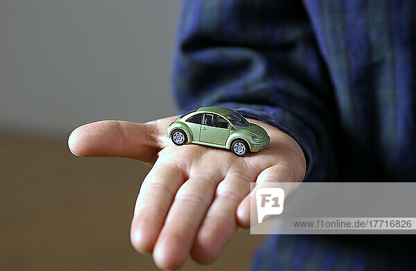 Boy Holding Mini Volkswagen Beetle