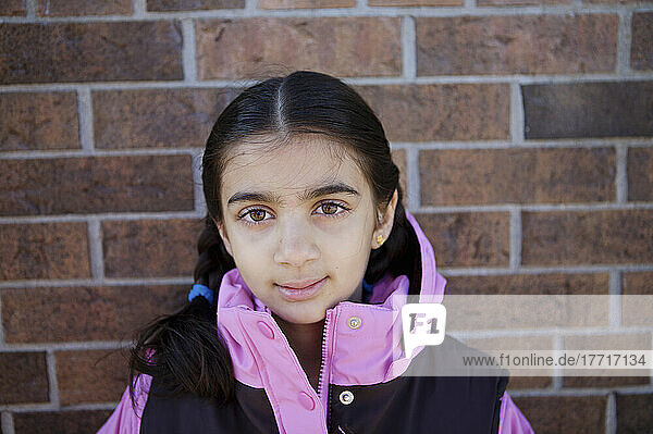 Indian Girl Against Brick Wall Of An Esl School; Guelph Ontario Canada