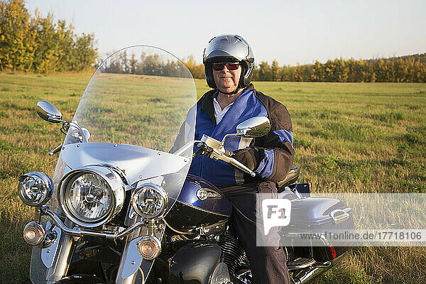 Mature Man In Field On A Motorcycle; Edmonton  Alberta  Canada