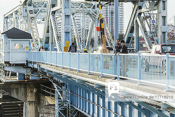A Young Indian Ethnicity Couple On Historical Johnson Street Bridge; Victoria  Vancouver Island  British Columbia