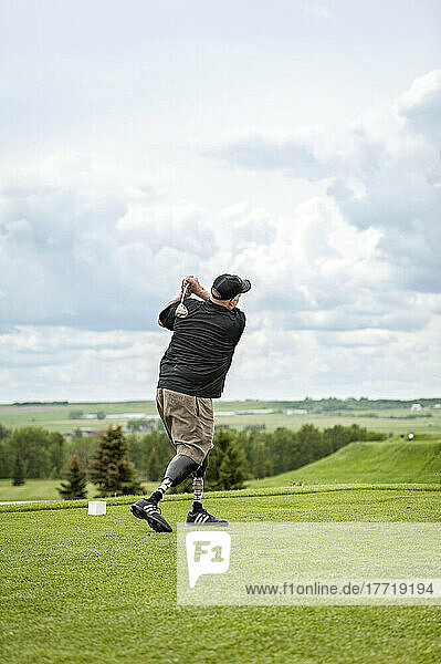 Double amputee with leg prosthetics on the golf course; Okotoks  Alberta  Canada