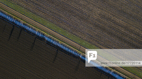 Drone photo of track running past ploughed fields early in the morning  Great Wilbraham; Cambridgeshire  England  United Kingdom