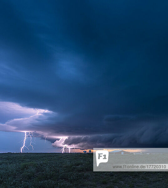 Lightning strikes from a supercell thunderstorm over the oil fields of New Mexico one evening; Maljamar  New Mexico  United States of America