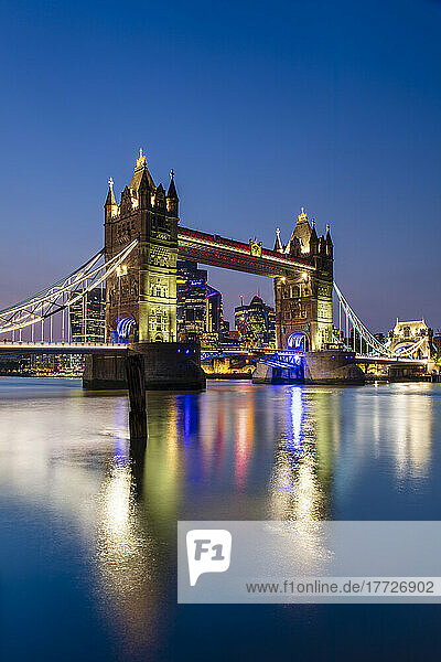 Tower Bridge and The City of London skyscrapers reflecting in River Thames at sunset  London  England  United Kingdom  Europe
