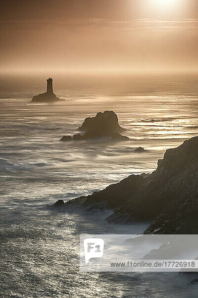 Pointe du Raz lighthouse and cliffs at sunset in Finisterre  Brittany  France  Europe