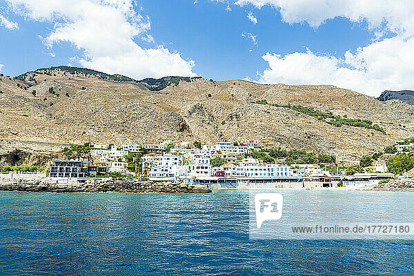 Seaside town resort of Hora Sfakion view from boat trip in the blue sea  Crete island  Greek Islands  Greece  Europe