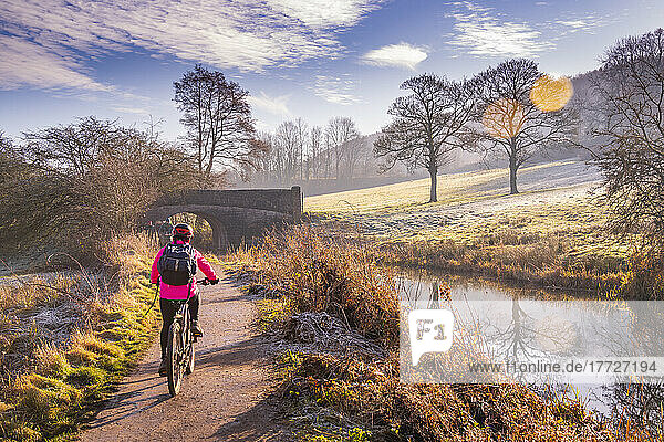 View of cyclist and frosty morning at the Cromford Canal  Derbyshire  England  United Kingdom  Europe