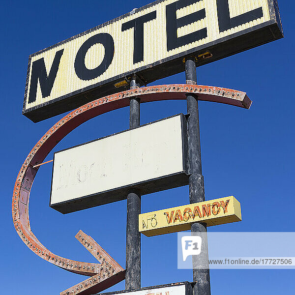 Old rusting Motel sign by the roadside.