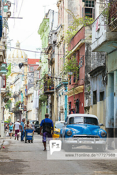 Blue vintage American car on busy street  Havana  Cuba  West Indies  Central America