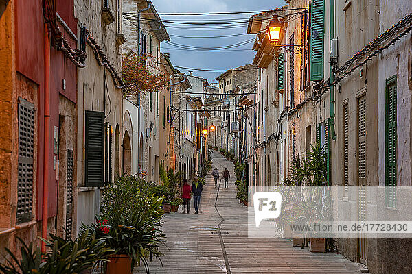 People in street in narrow street at dusk in the old town of Alcudia  Alcudia  Majorca  Balearic Islands  Spain  Mediterranean  Europe