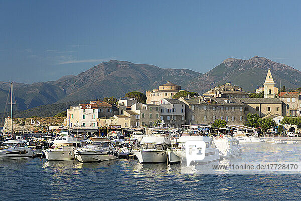 View across harbour to the town and citadel  hills of the Cap Corse peninsula beyond  St-Florent  Haute-Corse  Corsica  France  Mediterranean  Europe