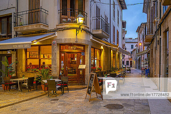 View of bar in narrow street in the old town of Pollenca at dusk  Pollenca  Majorca  Balearic Islands  Spain  Mediterranean  Europe