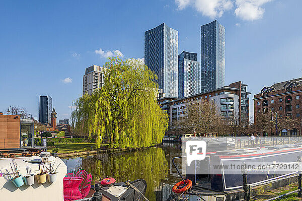 Skyscrapers reflected at Castlefield Basin with canal barges  Manchester  England  United Kingdom  Europe