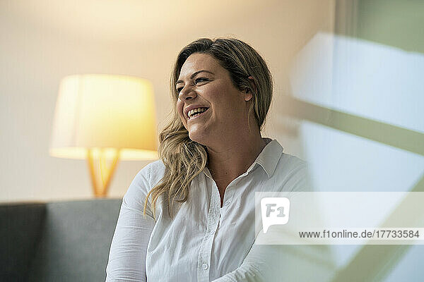 Blond businesswoman laughing at work place