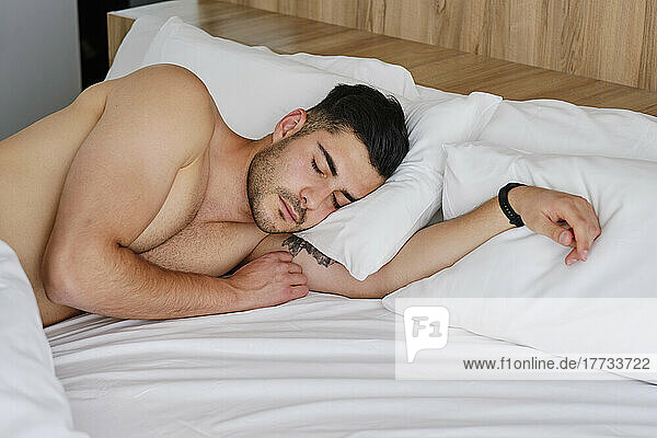 Man sleeping in bed at home