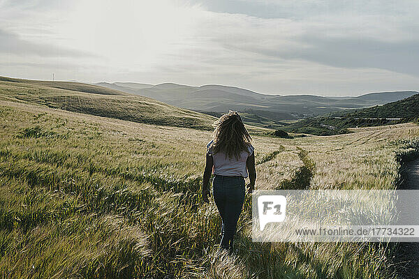 Young woman walking on meadow