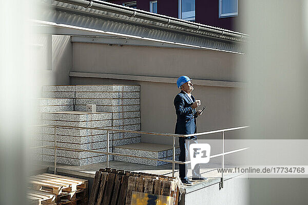 Senior businessman standing at construction site