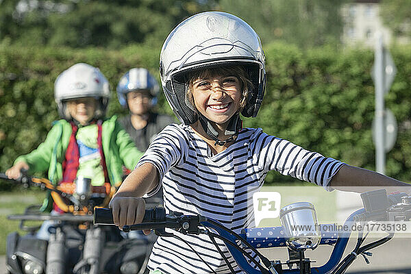 Smiling wearing sports helmet boy riding quadbike at traffic education training