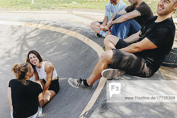 Happy friends enjoying at skateboard park
