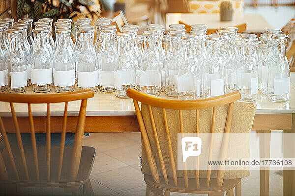 Empty glass bottles on table at cafe
