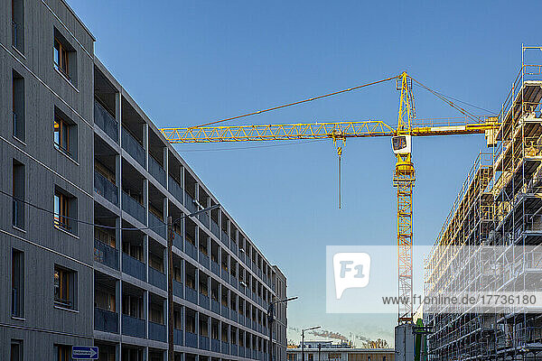 Germany  Bavaria  Munich  Construction site in Prinz-Eugen-Park complex with industrial crane standing in background