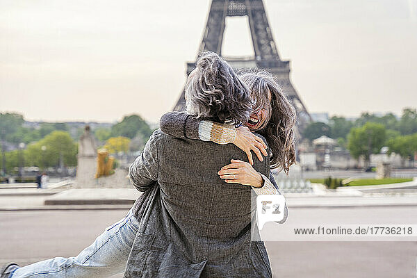 Happy mature man and woman enjoying in front of Eiffel Tower  Paris  France