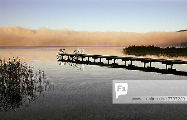Austria  Upper Austria  Bathing jetty on shore of Mondsee lake with thick morning fog in background