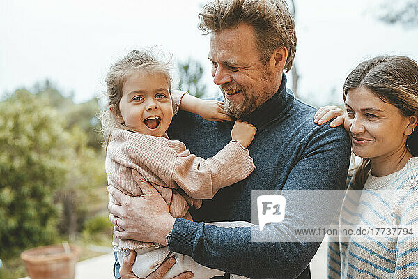 Happy cute girl with father and mother