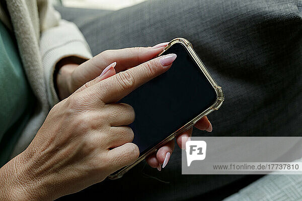 Woman touching smart phone screen