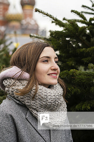 Smiling woman wearing scarf in Christmas market