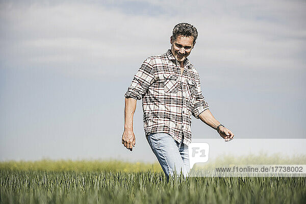 Happy man walking on field