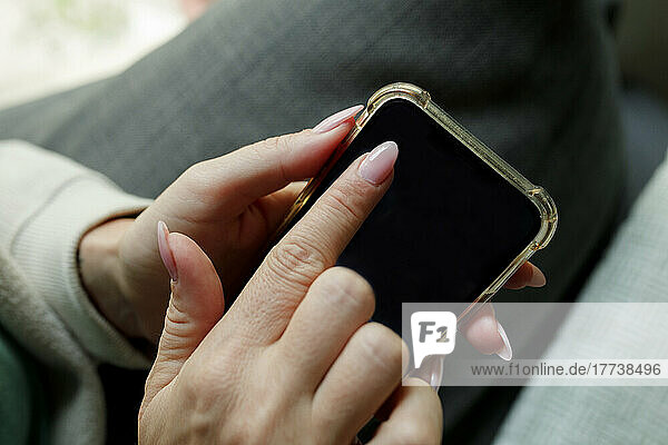 Woman touching mobile phone screen