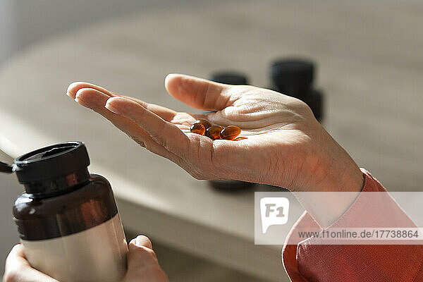 Close-up of woman holding pills