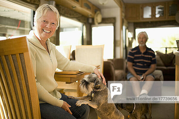 Senior couple wit dog in mobile home