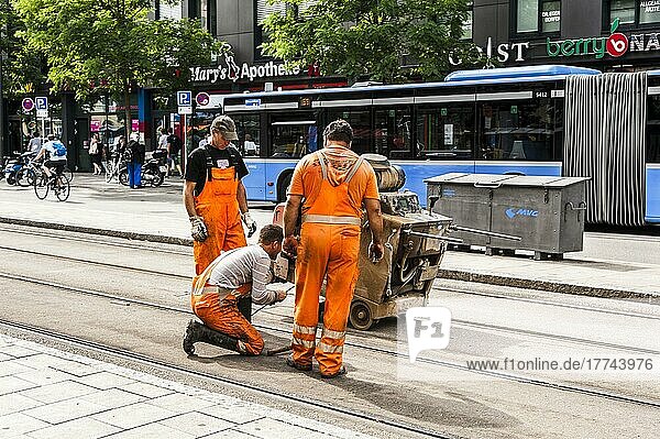 Moosach tram stop  construction worker doing track maintenance  machinery  Munich  Bavaria