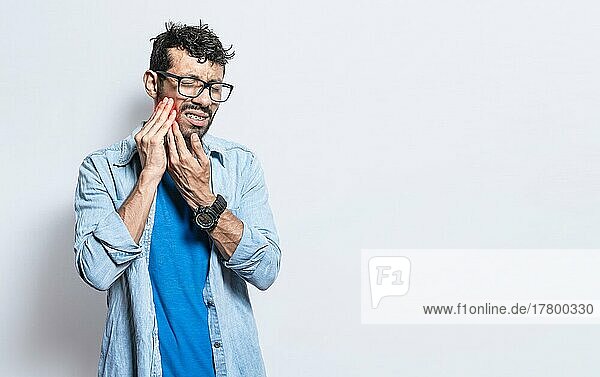 A man suffering from toothache isolated  People with toothache  person with hand on cheek with toothache. Concept of people with periodontitis