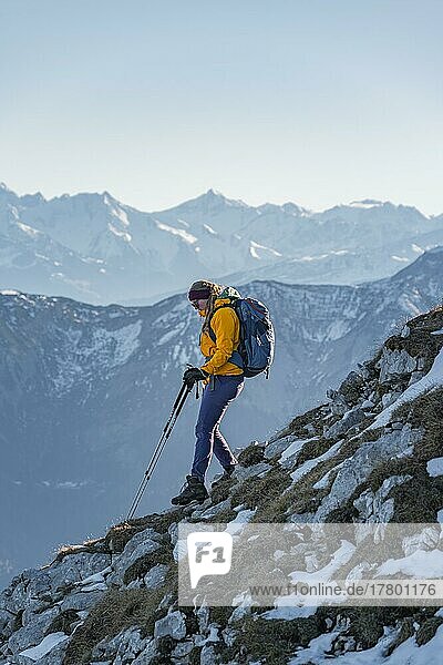 Climber on a ledge  snow-covered mountains  hiking to the Guffert in winter  Brandenberg Alps  Tyrol  Austria  Europe