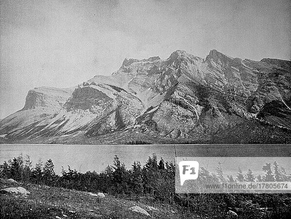 Lake Minnewanka is a glacial lake in the eastern area of Banff National Park in the province of Alberta  scenically located in the Rocky Mountains  ca 1880  Canada  Historic  digitally restored reproduction of a 19th century photographic original  North America