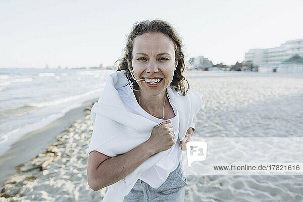 Happy woman running on beach