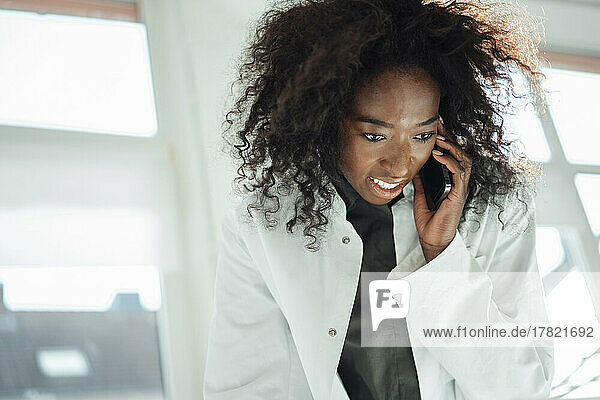 Female doctor talking on mobile phone