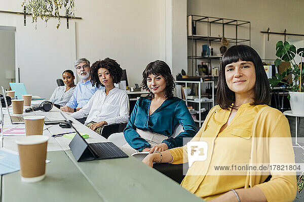 Multiracial business colleagues at desk in office