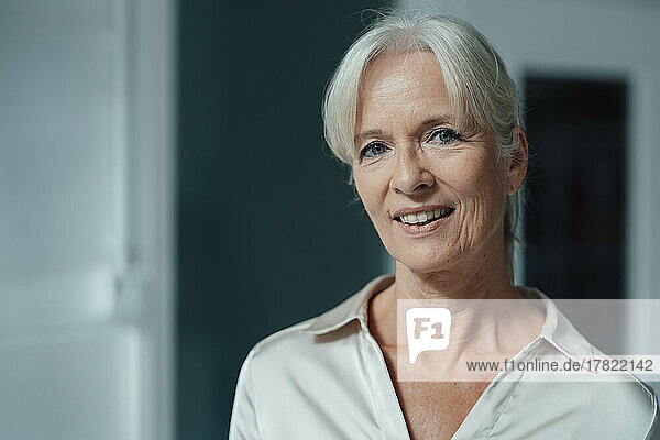 Happy senior businesswoman in office