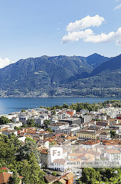 Switzerland  Ticino  Locarno  City houses with Lake Maggiore and surrounding mountains in background