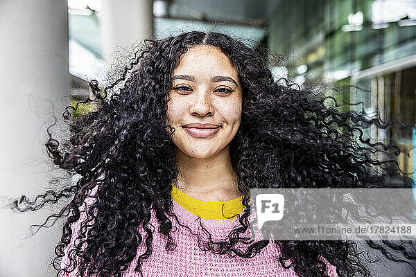 Smiling woman with black tousled hair