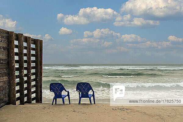 Israel  Tel Aviv District  Bat Yam  Two plastic chairs left on empty beach