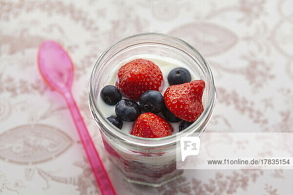 Yoghurt with granola  strawberries  raspberries and blueberries