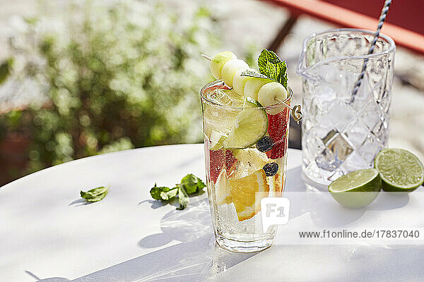 Refreshing summer fruit infused water with mixed fruit and melon skewers